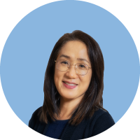 Headshot of Joyce Lee with blue background
